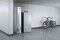 The picture shows the Vitocrossal 300 type CU3A gas condensing boiler with a Vitocell DHW cylinder in a basement, next to a mountain bike.